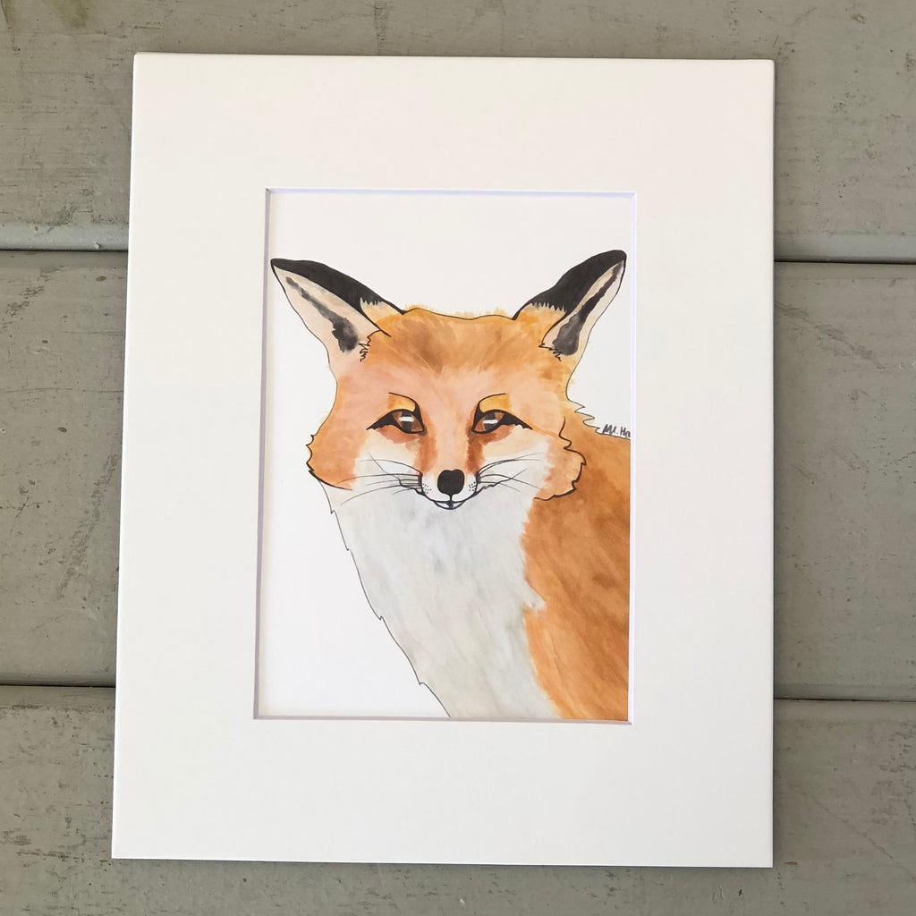Pictured is a print designed by artist Maddie Hart and sold at The Hare & The Hart in downtown Thomasville, Georgia. It is an 5" x 7", matted to 8" x 10", print of a watercolor fox.