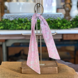 Pictured is Liberty London Hair Scarf in the pattern Pink Capel sold at The Hare & The Hart in downtown Thomasville, Georgia. It is a scarf made from pink and white floral fabric.