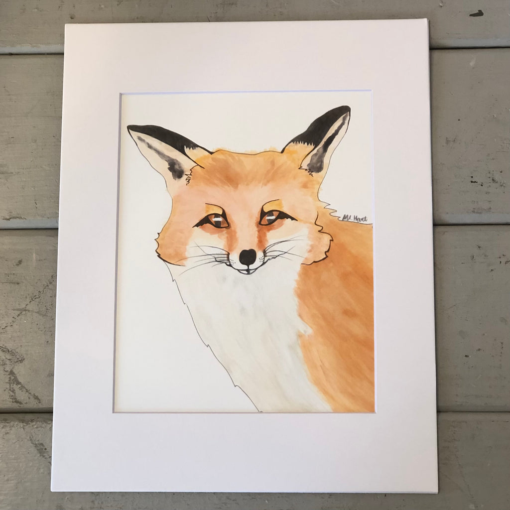 Pictured is a print designed by artist Maddie Hart and sold at The Hare & The Hart in downtown Thomasville, Georgia. It is an 8"x 10", matted to 11" x 14", print of a watercolor fox.