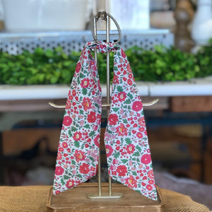 Pictured is Liberty London Hair Scarf in the pattern D'anjo Pink sold at The Hare & The Hart in downtown Thomasville, Georgia. It is a scarf made from blue, pink, and green floral fabric.