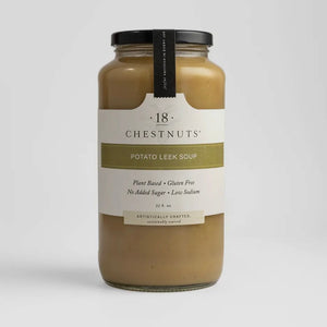Pictured is a jar of 18 Chestnuts Potato Leek Soup sold at The Hare & The Hart in downtown Thomasville, Georgia. It is yellow color. The label reads, "plant based, gluten free, no added sugar, low sodium"