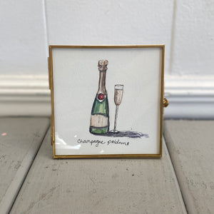 Pictured is Champagne Problems 4" x 4" Painting by Sarah Healy sold at The Hare & The Hart in downtown Thomasville, Georgia. It is a watercolor painting of a bottle of champagne next to a full champagne glass and the words "champagne problems"