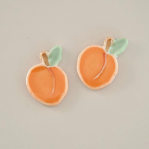Pictured are a pair of porcelain peach stud earrings sold at The Hare & The Hart in downtown Thomasville, Georgia.