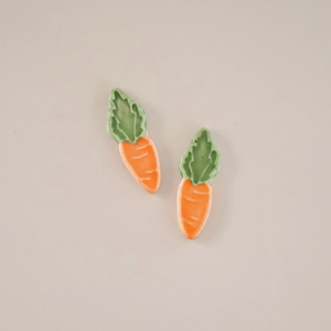 Pictured are a pair of porcelain carrot stud earrings sold at The Hare & The Hart in downtown Thomasville, Georgia.