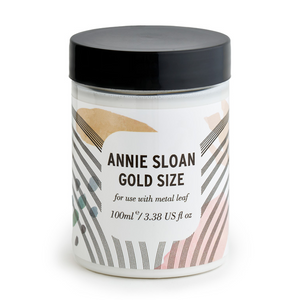 Pictured is a container of Annie Sloan® Gold Size sold at The Hare & The Hart in downtown Thomasville, Georgia. The container reads, "ANNIE SLOAN GOLD SIZE for use with metal leaf 100ml/3.38 US fl oz.