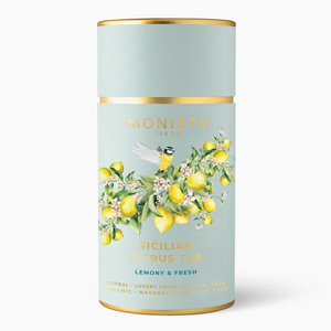 Pictured is a canister of Sicilian Citrus Tea by Monista sold at The Hare & The Hart in downtown Thomasville, Georgia. It is a minty green color with artwork of a bird sitting on a branch from a lemon tree, abundant with lemons and flowers. The container reads, "Monista Tea Co. Sicilian Citrus Tea Lemony & Fresh"