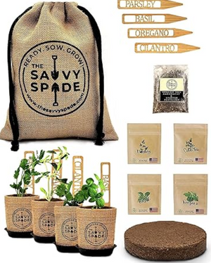 Pictured is the Coctail Garden Kit by The Savvy Spade sold at The Hare & The Hart in downtown Thomasville, Georgia. In the picture are all of the components of teh kit, including a burlap bag with the logo printed on it, labels for each herb, a bag of soil, four different herb seeds (parsley, basil, oregano, and cliantro), and a puck of fertilizer. In the bottom left section of the image are the four herbs fully grown and in their burlap pots.