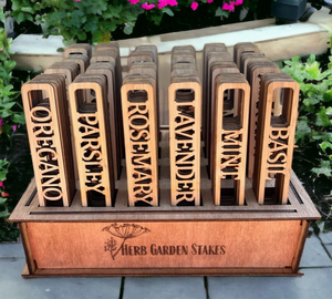 Pictured is a set of Herb Garden Marker Set by The Savvy Spade sold at The Hare & The Hart in downtown Thomasville, Georgia. In the picture are several sets of herb garden markers in a display case. The herbs are oregano, parsley, rosemary, lavender, mint, and basil.