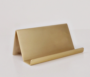 Pictured is a Brass Card Holder by emily lex studio and sold at The Hare & The Hart in downtown Thomasville, Georgia.