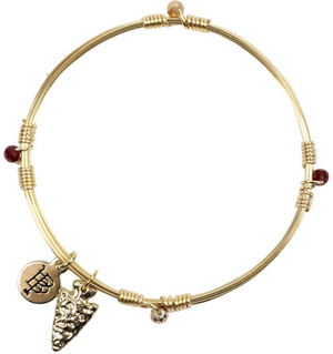 Pictured is the Gameday Bangle by Bourbon and Bowties sold at The Hare & The Hart in downtown Thomasville, Georgia. It is a Gold plated copper wire single bangle stacker with beads. Finished with a gold tag and a charm.