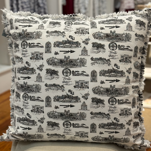 Pictured is a square pillow covered with Toile of FSU black and white patterned fabric. The edges of the pillow are frayed.