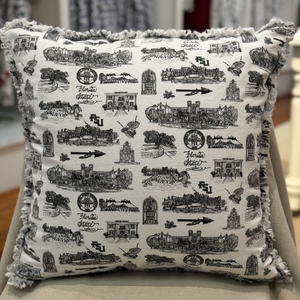 Pictured is a square pillow covered with Toile of FSU black and white patterned fabric. The edges of the pillow are frayed.