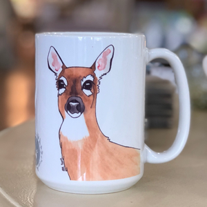 Pictured is a white coffee mug with a watercolor design of a black bear on it.