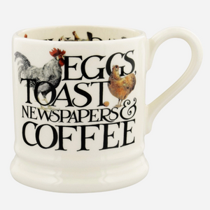 Pictured is a Rise & Shine Mug by Emma Bridgewater and sold at The Hare & The Hart in downtown Thomasville, Georgia. It is a large coffee mug that says, "EGGS, TOAST, NEWSPAPERS & COFFEE" and has illustrations of a rooster and a chicken.