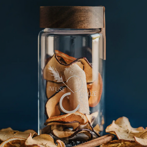 Pictured is The Tailgater by Infuse & Booze sold at The Hare & The Hart in downtown Thomasville, Georgia. It is a glass bottle with a wooden lid filled with cocktail ingredients.