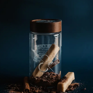 Pictured is a Mocha-tini Espresso Martini by Infuse & Booze sold at The Hare & The Hart in downtown Thomasville, Georgia. It is a glass jar with a wooden lid filled with cocktail ingredients.