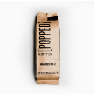 Pictured is a Gingerbread Caramel Artisan Popcorn by [POPPED] sold at The Hare & The Hart in downtown Thomasville, Georgia. It is a brown paper bag of artisan popcorn in gingerbread flavor.