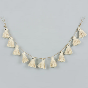 Pictured is a Halloween Ghost Tassel Garland sold at The Hare & The Hart in downtown Thomasville, Georgia. It is a garland with white ghosts made from tassels.