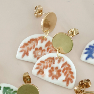 Pictured is Orange Fanfare Dangle Earrings sold at The Hare & The Hart in downtown Thomasville, Georgia.