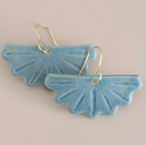 Pictured is a pair of Blue Fan Porcelain Earrings by Being Sara Dixon studio sold at The Hare & The Hart in downtown Thomasville, Georgia.