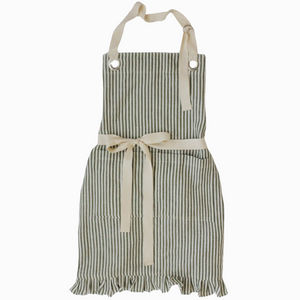 Pictured is Ruffle Pin Stripe Apron in Rust Stripe sold at The Hare & The Hart in downtown Thomasville, Georgia. It is a cotton and linen blend apron with a ruffle on the bottom and a black striped pattern.