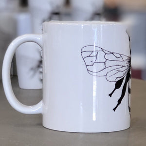 A small white mug with a bee design pictured from the side. This is a Small Mug by Birds & Bees sold at The Hare & The Hart.