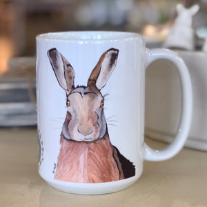 Open image in slideshow, Pictured is a white coffe mug with a watercolor design of a hare on it.
