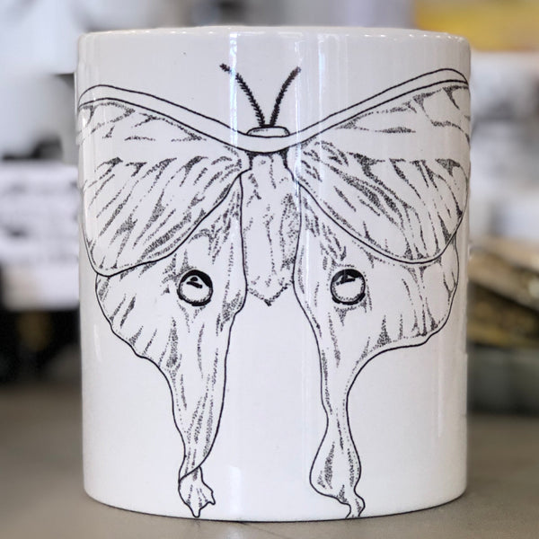 A large white mug with a black luna moth design in the center of it. This is a Large Mug by Birds & Bees sold at The Hare & The Hart.