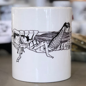 Open image in slideshow, A large white mug with a black grasshopper design on it. This is a Large Mug by Birds &amp; Bees sold at The Hare &amp; The Hart.

