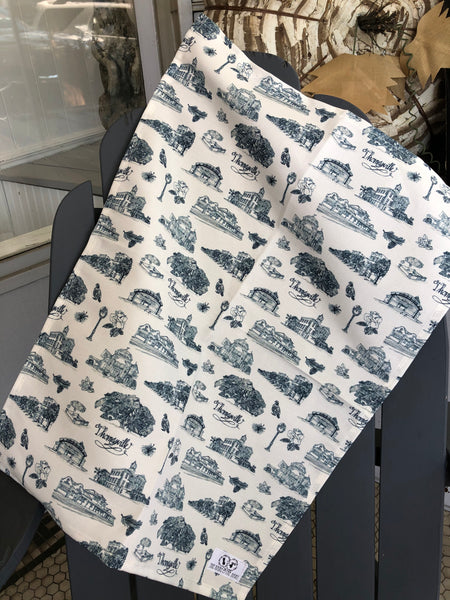 There is a tea towel made of blue and white Toile of Thomasville fabric.