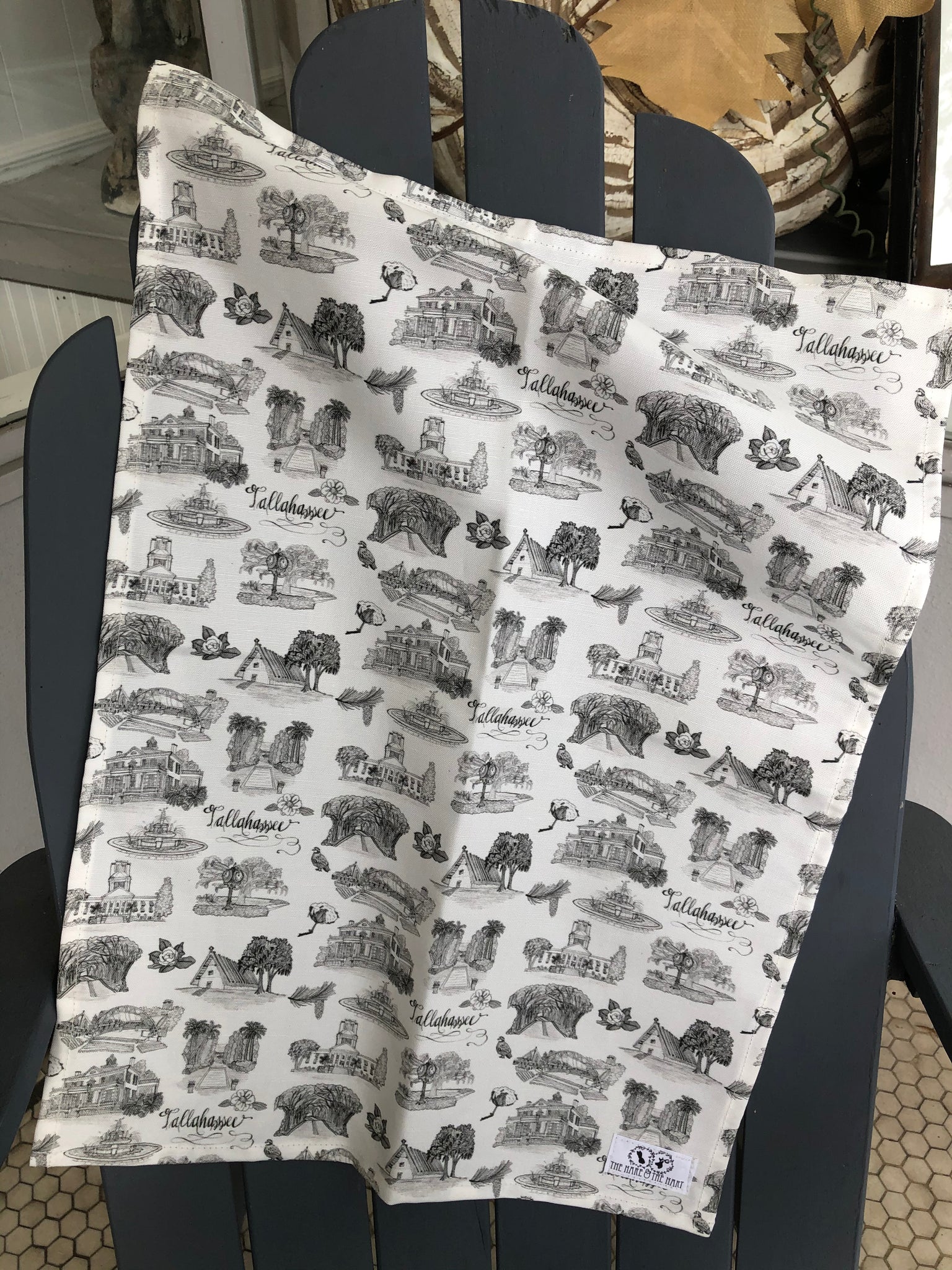 There is a tea towel made of black and white Toile of Tallahassee fabric.