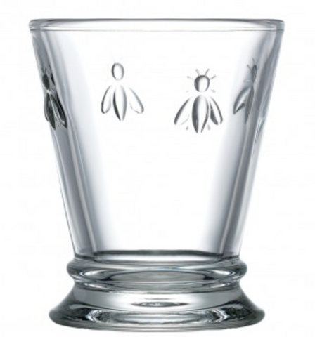 A clear glass tumbler glass with four bees embossed on it. This is a Bee Tumbler by La Rochere sold at The Hare & The Hart.