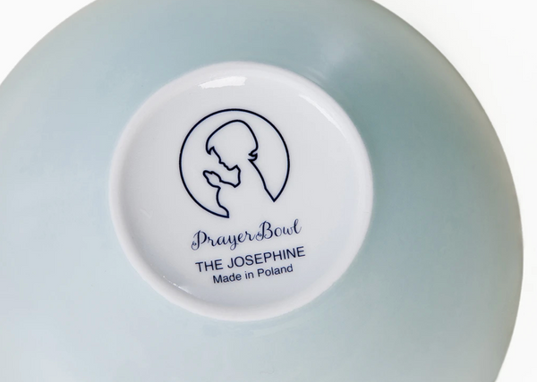 Pictured is the bottom of the Josephine Prayer Bowl. It is all light blue except for the base, which is white and printed with the Prayer Bowls logo.