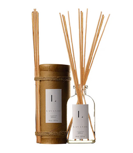 Pictured is two Lavende Diffusers. One is still in its cylinder container with the sticks tied to the side. The second one is open. It's in a glass bottle with the Lavende label and the wooden sticks are inside it.