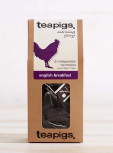 Pictured is a rectangular package of Teapigs English Breakfast Tea. There is a clear plastic window on the packaging that the teabags can be seen through. There is a white label with a purple rooster and the words "teapigs morning glory 15 biogradable tea temples english breakfast."