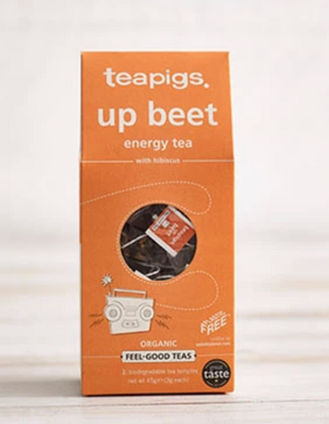 Pictured is the packaging for Teapigs Organic Upbeet Tea. It is an orange and has an illustration of a boombox. The label reads "teapigs up beet energy tea with hibiscus organic feel-good teas."