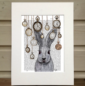 Pictured is a page from a book framed with mat. Printed over the book page is the head and shoulders of a rabbit surrounded by pocket watches hanging from their chains from the top of the page, all hanging at various heights.