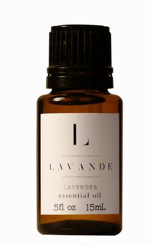 Pictured is a small dark glass bottle with a twist top. It has a white label that reads "L LAVANDE LAVENDER essential oil"