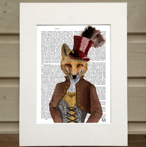Pictured is a page out of a book framed in mat. An opaque print of a figure is over the page. The figure wears an old fasioned outfit with a corset top and a jacket with a popped collar, and a top hat with a feather sticking out of the top. The figure has the head of a red fox instead of that of a human.