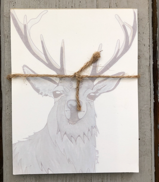 There is a notepad tied together with twice. The paper of the notepad is printed with a design of a stag.