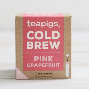 Pictured is a container of teapigs Pink Grapefruit Cold Brew. The container is a cardboard box with coral accents. The label reads "teapigs COLD BREW PINK GRAPEFRUIT 10 tea temples for your water bottle."