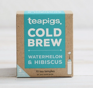 Pictured is a container of teapigs Watermelon & Hibiscus Cold Brew. The container is a cardboard box with aqua accents. The label reads "teapigs COLD BREW WATERMELON & HIBISCUS 10 tea temples for your water bottle."