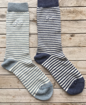 Open image in slideshow, Pictured are two Samantha Holmes Alpaca Stripey Socks. There is one light blue sock and one dark blue sock. These are sold at The Hare &amp; The Hart in Thomasville, GA.
