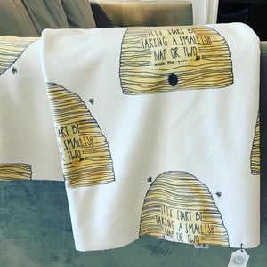 Pictured is a literary quote sherpa blanket by artist Maddie Hart and sold at The Hare & The Hart in downtown Thomasville, Georgia.