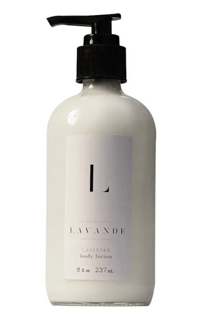 Pictured is a Body Lotion 2 Oz. by Lavande and sold at The Hare & The Hart in downtown Thomasville, Georgia. It is a glass lotion dispenser with a pump top lid. It is filled with lotion and it has a white label on it that reads "L LAVANDE LAVENDER body lotion"