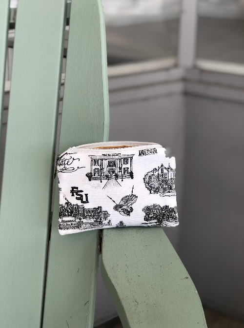Pictured is a coin purse sized pouch made of Toile of FSU black and white fabric. It has a zipper closure.
